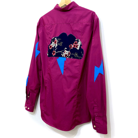Upcycled fuschia button shirt with handsewn floral clouds and bright blue lightening bolts sewn on by hand